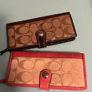 Coach wallets. Two of them. Brown and pink. Used.